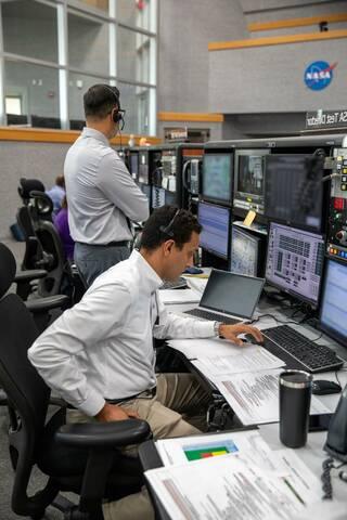 NASA Test Director Sharif Abdel-Magid, seated, and Carlos Monge, branch chief for Test, Launch, and Recovery Operations, rehearse the steps to launch NASA’s Space Launch System and Orion spacecraft for the Artemis II crewed mission.